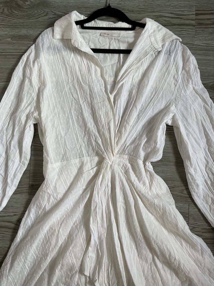 Maje White Ritellio Dress (Category: Dresses) located in Muntinlupa City. Submitted by lovedbysabel (Listing ID 1463642056, Image 3). Description: Bought for 400+ USD. Selling for ₱5k only! Still negotiable Short mini shirt dress featuring white cotton voile with subtle jacquard textures, loose-fitting long sleeves with elasticated cuffs, a classic shirt collar, and a signature gathered twist-front knot detail at the waist.