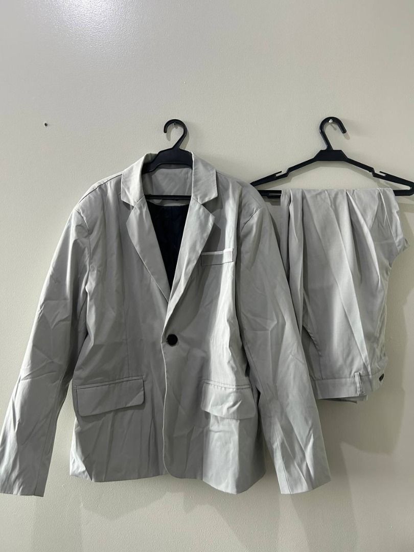 MANFINITY Gray Suit Set (Category: Coats, Jackets and Outerwear) located in Taguig. Submitted by MoveQuickly (Listing ID 1463627566, Image 1). Description: - MANFINITY Suit Set - Includes single-button blazer and matching pants - Blazer features 2 front pockets and black inner lining - Size: Pants: 38W x 18L | Blazer: 20W x 29L.