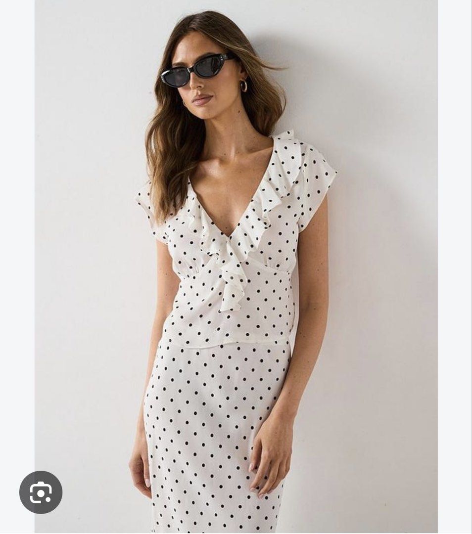 Mango White Black Polka Dot Ruffle Tie Front Top (Category: Blouses) located in Taguig. Submitted by beatrizangela (Listing ID 1462495522, Image 3). Description: - Cute white top with black polka dots - Features a ruffled neckline - Tie front detail - Short sleeves - Can be tied at the waist or worn loose - Easy to style for casual or dressy occasions.