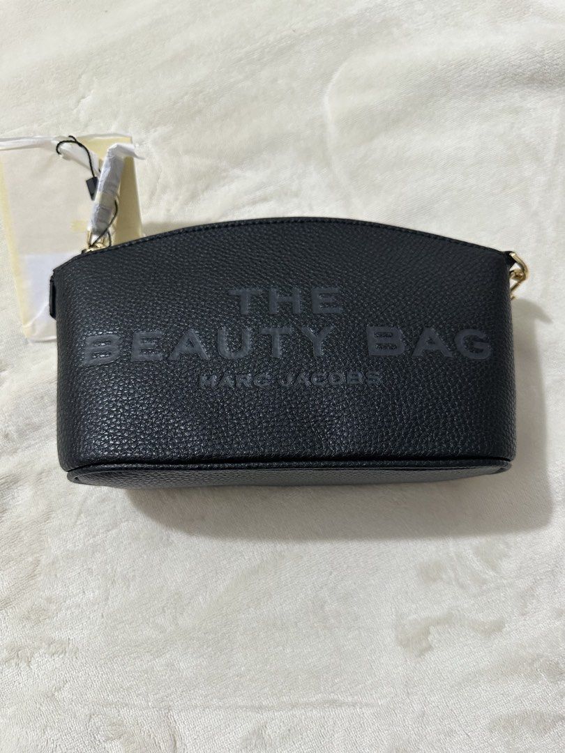 Marc Jacobs The Beauty Bag Black Leather (Category: Luxury Bags & Wallets) located in Makati City. Submitted by twitchel (Listing ID 1463732499, Image 1). Description: - Authentic Marc Jacobs black leather beauty bag - Features embossed logo on the front - Stylish gold chain detail - Comes with original packaging - Ideal for organizing makeup or as a chic clutch.