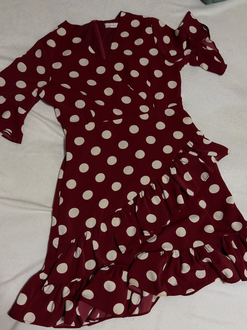 Maroon Polka Dot Ruffle Dress (Medium) (Category: Dresses) located in Cebu City. Submitted by eynjlin (Listing ID 1463689524, Image 1). Description: - Adorable maroon dress with classic white polka dots. - Features charming ruffled details on the skirt and sleeves. - Flattering V-neckline with a convenient back zipper closure. - Made from lightweight, flowy fabric for comfortable wear. - Versatile style, ideal for parties or casual outings. - Des