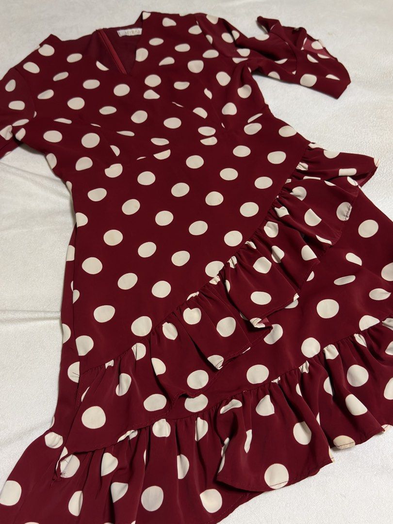 Maroon Polka Dot Ruffle Dress (Medium) (Category: Dresses) located in Cebu City. Submitted by eynjlin (Listing ID 1463689524, Image 2). Description: - Adorable maroon dress with classic white polka dots. - Features charming ruffled details on the skirt and sleeves. - Flattering V-neckline with a convenient back zipper closure. - Made from lightweight, flowy fabric for comfortable wear. - Versatile style, ideal for parties or casual outings. - Des
