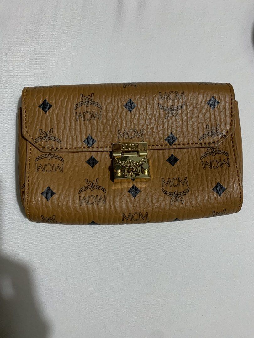 MCM Cognac Visetos wallet Bag on Chain (Category: Luxury Bags & Wallets) located in Cavite. Submitted by honeyjmo (Listing ID 1463595437, Image 1). Description: - Authentic MCM clutch bag - Classic Visetos monogram print - Gold hardware - Detachable gold chain strap - Interior zip pocket - Perfect for carrying your essentials - No inclusions- bag only - Gift - For self authentication.