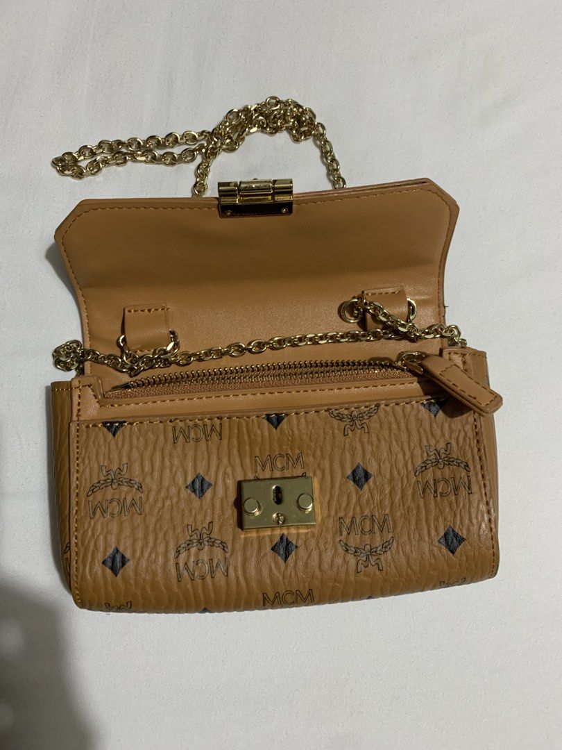 MCM Cognac Visetos wallet Bag on Chain (Category: Luxury Bags & Wallets) located in Cavite. Submitted by honeyjmo (Listing ID 1463595437, Image 3). Description: - Authentic MCM clutch bag - Classic Visetos monogram print - Gold hardware - Detachable gold chain strap - Interior zip pocket - Perfect for carrying your essentials - No inclusions- bag only - Gift - For self authentication.