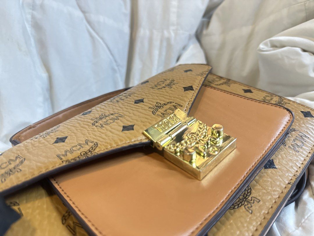 MCM Visetos Monogram Shoulder Bag (Category: Luxury Bags & Wallets) located in Quezon City. Submitted by mnmcollections (Listing ID 1463649504, Image 2). Description: -Preloved Coded, Good Condition - Classic MCM shoulder bag - Signature Visetos monogram in tan and brown - Gold-tone hardware - Secure clasp closure - Interior zip pocket - Detachable shoulder strap included - Ideal for everyday use.