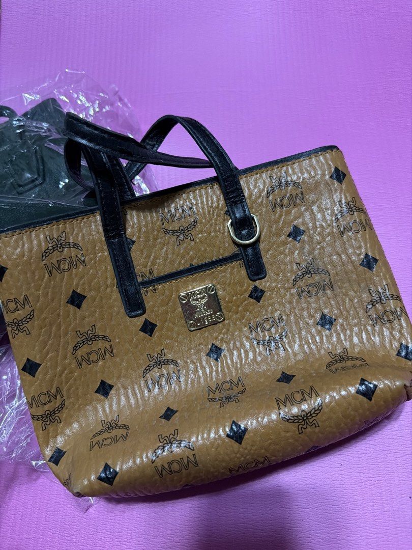 MCM Visetos Tote Bag (Category: Tote Bags) located in Manila. Submitted by salvadorsh41571 (Listing ID 1463705864, Image 1). Description: - Authentic MCM tote bag in brown - Iconic Visetos pattern all over - Black leather top handles - Gold-tone MCM logo plate on the front - Ideal for everyday carry.