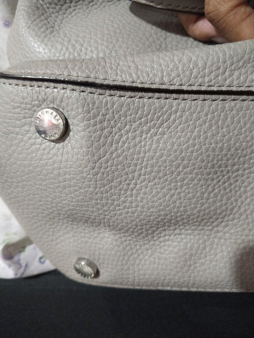 Michael Kors Grey Leather Tote Handbag (Category: Tote Bags) located in Quezon City. Submitted by goshen24 (Listing ID 1463669516, Image 2). Description: - Brand: Michael Kors - Material: Grey pebbled leather - Style: Tote bag - Hardware: Silver-tone - Interior: Multiple zip and slip pockets - Ideal for: Everyday use original minimal stain.