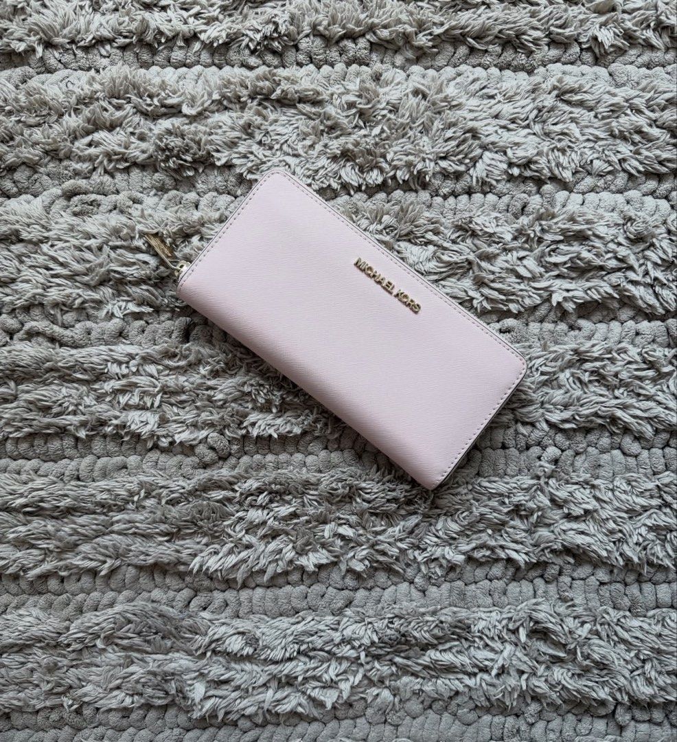 Michael Kors Long Zip Wallet (Category: Luxury Bags & Wallets) located in Quezon City. Submitted by declutteringcloset18 (Listing ID 1463599101, Image 1). Description: Light pink w/ gold hardware Note hardware tarnish and interior dirt No tears or rips Retails ~10k++.