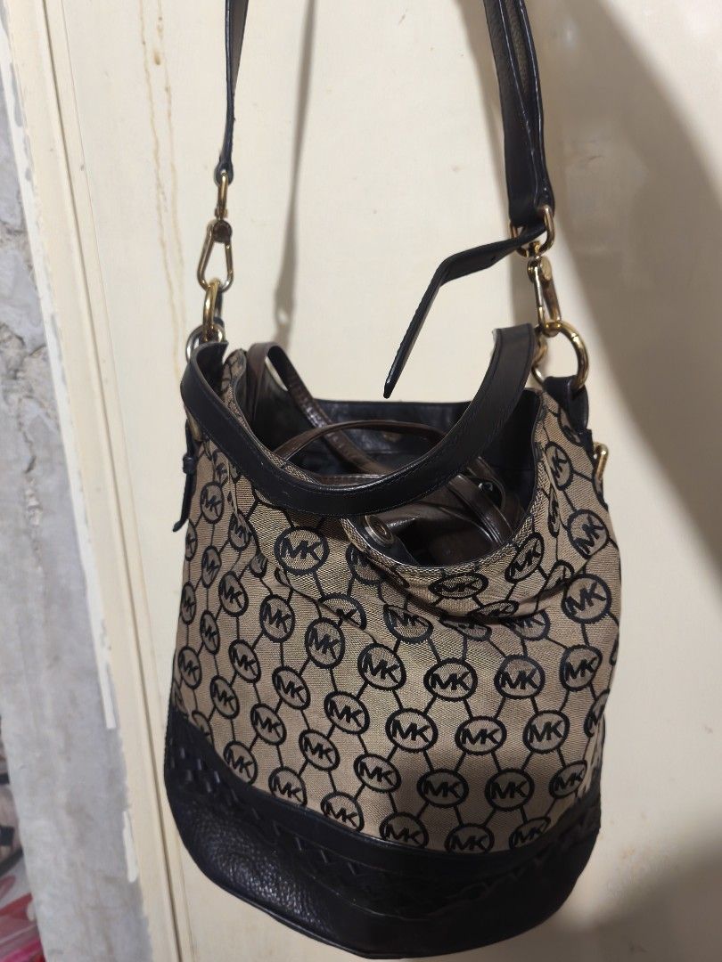 Michael Kors Monogram Bucket Bag (Category: Luxury Bags & Wallets) located in Plaridel. Submitted by julleyuuuh (Listing ID 1463592764, Image 1). Description: - Authentic Michael Kors bucket bag - Classic MK monogram pattern - Tan and black colorway - Genuine leather trim and strap - Gold-tone hardware - Perfect for everyday use.