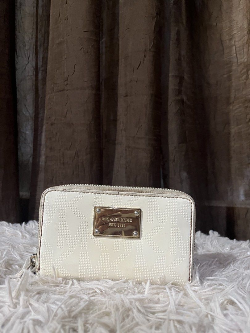 Michael Kors White Monogram Zip Around Wallet (Category: Luxury Bags & Wallets) located in Davao. Submitted by loved.ones0606 (Listing ID 1463557876, Image 1). Description: - White Michael Kors wallet - Signature monogram pattern - Zip-around closure - Multiple interior card slots and compartments - Gold-tone hardware - Minor marks on exterior (please check photos) color transfer back portion.