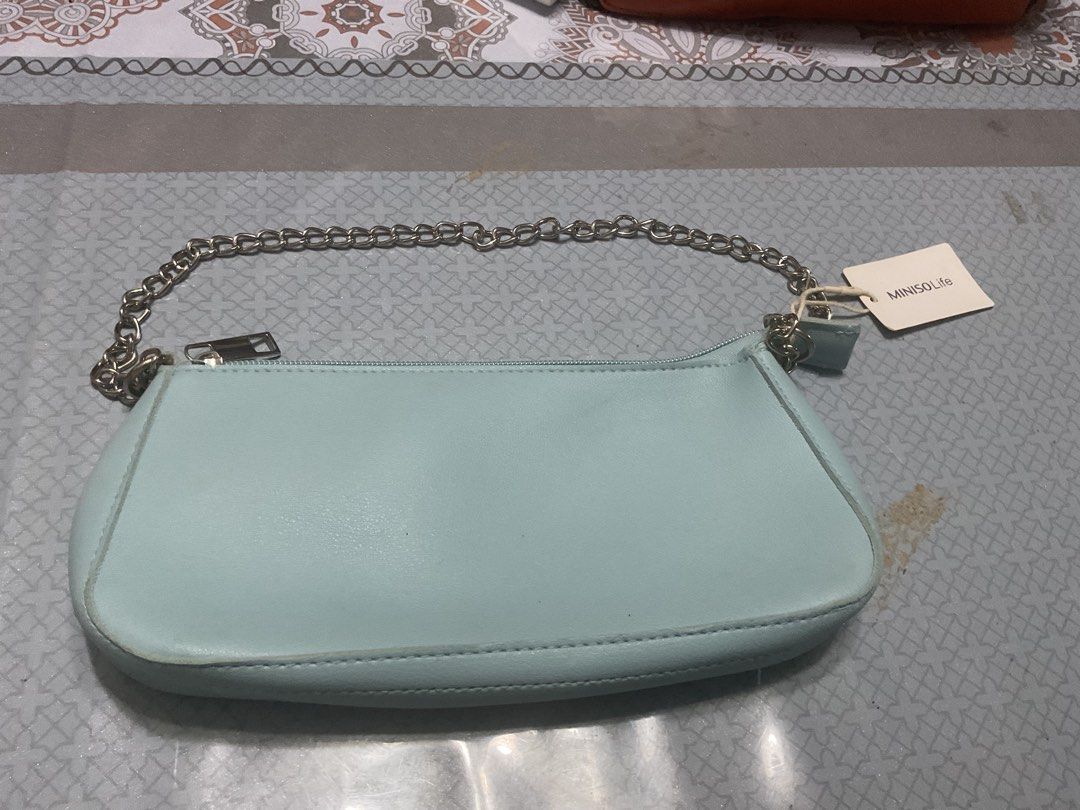 MINISO Life Light Blue Shoulder Bag with Chain Strap (Category: Shoulder Bags) located in Iloilo. Submitted by clutter_sie (Listing ID 1463581605, Image 1). Description: - Light blue shoulder bag from MINISO Life - Features a stylish silver chain strap - Secure zipper closure - Compact size, ideal for carrying essentials - Brand new with original tag still attached.