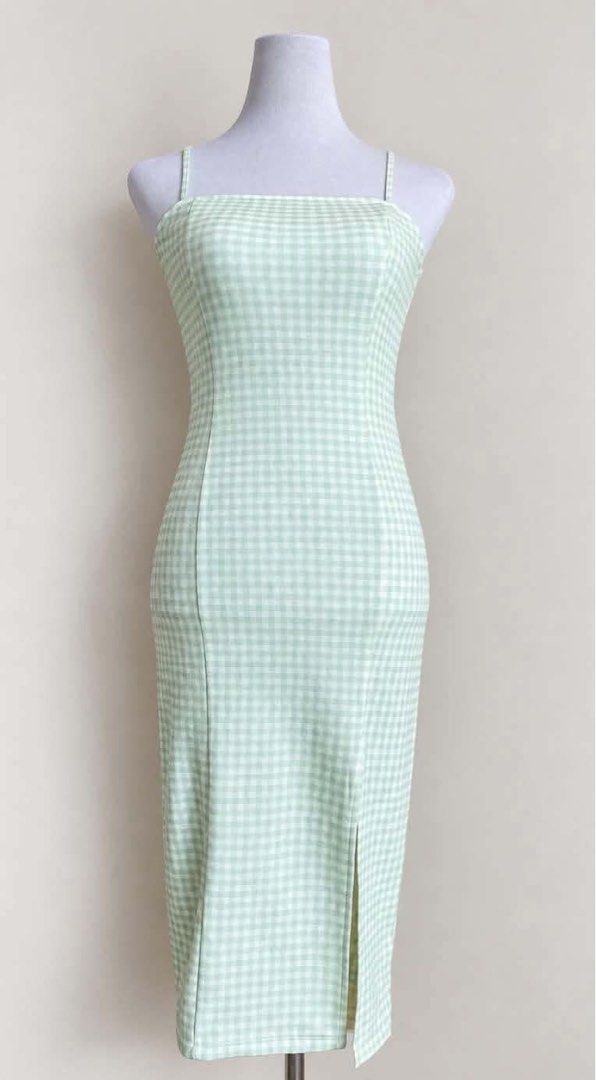 Mint Green Gingham Square Neck Midi Dress with Slit (Category: Dresses) located in Manila. Submitted by autumn.apparel (Listing ID 1463668859, Image 1). Description: - Adorable mint green gingham pattern - Flattering square neckline with thin straps - Chic midi length with a stylish side slit - Fitted silhouette for a sleek look - Versatile for casual days, picnics, or outings - Effortlessly pairs with sandals or sneakers.