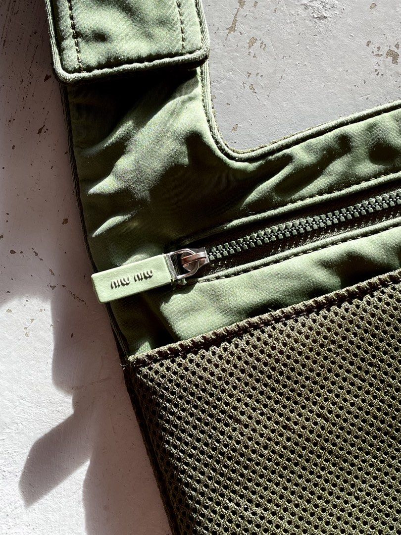 Miu Miu Mesh Crossbody Bag (Category: Luxury Bags & Wallets) located in San Fernando. Submitted by larchivefeminine (Listing ID 1463700243, Image 3). Description: Miu Miu Mesh Crossbody Bag SS 1999 VERY GOOD VINTAGE CONDITION NORMAL SIGNS OF WEAR FOR VINTAGE MADE IN ITALY COLOR: GREEN / OLIVE GREEN ZIPPER: RIRI MATERIAL: BALLISTIC MESH FABRIC OVERLY .