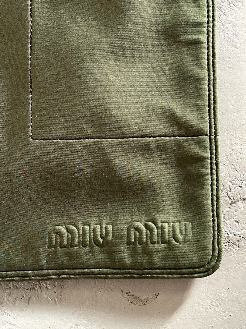 Miu Miu Technical Nylon Cross Body Bag (Category: Luxury Bags & Wallets) located in San Fernando. Submitted by larchivefeminine (Listing ID 1463699554, Image 3). Description: Miu Miu Technical Nylon Cross Body Bag SS 1999 VERY GOOD VINTAGE CONDITION NORMAL SIGNS OF WEAR FOR VINTAGE (Napatakan lang ng water) MADE IN ITALY COLOR: GREEN / OLIVE GREEN ZIPPER: OPTI MATERIAL:TECHNICAL NYLON FABRIC.