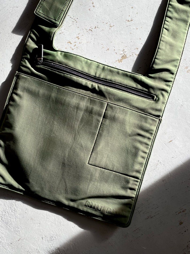 Miu Miu Technical Nylon Cross Body Bag (Category: Luxury Bags & Wallets) located in San Fernando. Submitted by larchivefeminine (Listing ID 1463699928, Image 2). Description: Miu Miu Technical Nylon Cross Body Bag SS 1999 VERY GOOD VINTAGE CONDITION MADE IN ITALY COLOR: GREEN / OLIVE GREEN ZIPPER: LAMPO MATERIAL: TECHNICAL NYLON FABRIC .