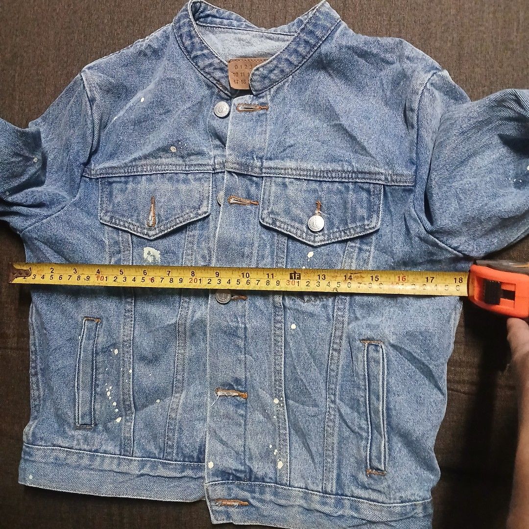 MM6 Maison Margiela Paint Splatter Collarless Denim Jacket (Category: Coats, Jackets and Outerwear) located in Cagayan de Oro. Submitted by susanthrifts (Listing ID 1463596732, Image 2). Description: ​Brand: MM6 Maison Margiela (0ff/Legit) ​Size: Small (S) ​Measurements: ​Chest (Pit to Pit): 18" ​Length: 20" ​Details: ​Light blue washed denim with factory paint splatter detailing ​Collarless / Mandarin collar neck design ​Signature circled '6' in