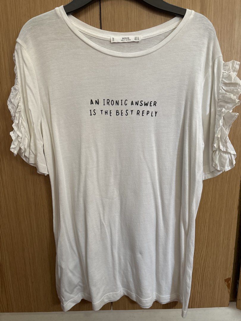 MNG White T-shirt with Ruffle Sleeves (Category: Shirts) located in Quezon City. Submitted by thebookwyrm (Listing ID 1463630505, Image 1). Description: - White MNG t-shirt - Features a fun slogan: 'AN IRONIC ANSWER IS THE BEST REPLY' - Cute ruffle details on the sleeves - Made from soft, comfortable fabric - Ideal for casual wear - Easily pairs with jeans or shorts ***sizes are based on tags***.
