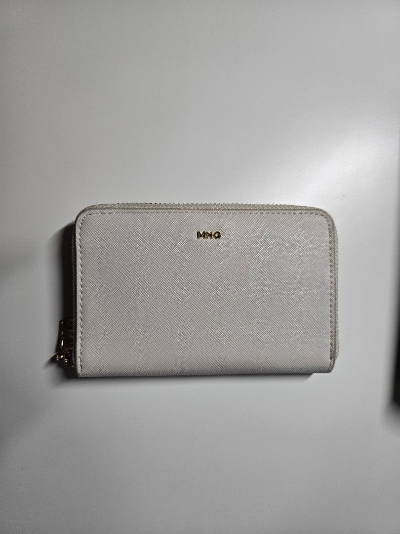 MNG Zip Around Wallet (Category: Wallets & Card holders) located in Cagayan de Oro. Submitted by itsnaja (Listing ID 1463691895, Image 1). Description: - White MNG wallet - Zip-around closure - Multiple card slots - Zippered compartment in the middle - Gold hardware - Clean interior - Great for organizing essentials.