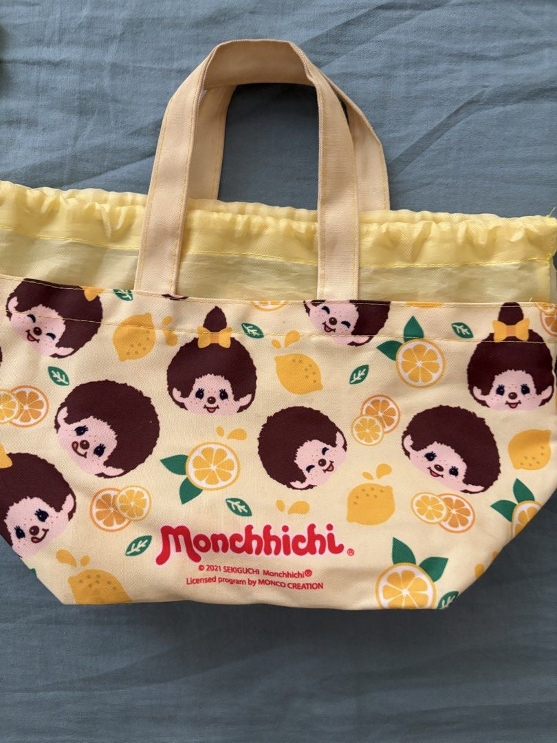 Monchhichi Lemon Print Small Drawstring Bag (Category: Tote Bags) located in Manila. Submitted by anabri (Listing ID 1463609372, Image 2). Description: - Adorable Monchhichi bag with a vibrant lemon print. - Cheerful yellow color featuring iconic Monchhichi characters. - Equipped with convenient handles for easy carrying. - Secure drawstring closure to keep contents safe. - Ideal for snacks, lunch, or storing small essentials. - Perfect for both 