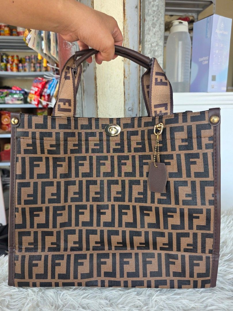 Monogram Tote Bag (Category: Tote Bags) located in Lemery. Submitted by venus23 (Listing ID 1463740460, Image 1). Description: - Classic monogram tote bag - Iconic brown and black FF pattern - Gold hardware details - Purple interior lining - Interior zippered pocket - Ideal for everyday use or travel.