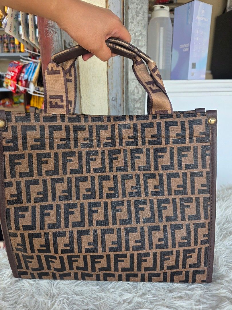 Monogram Tote Bag (Category: Tote Bags) located in Lemery. Submitted by venus23 (Listing ID 1463740460, Image 2). Description: - Classic monogram tote bag - Iconic brown and black FF pattern - Gold hardware details - Purple interior lining - Interior zippered pocket - Ideal for everyday use or travel.