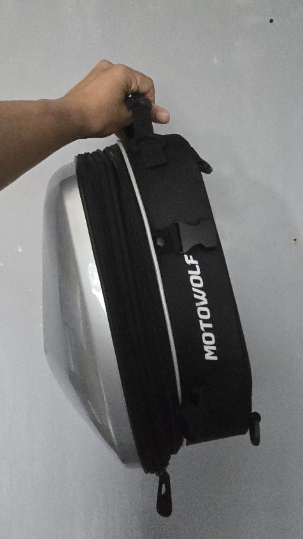 Motowolf Motorcycle Tail Bag Hard Shell Silver (Category: Luxury Bags & Wallets) located in Caloocan City. Submitted by marces (Listing ID 1463602437, Image 2). Description: - Silver hard shell motorcycle tail bag - Black fabric top with 'MOTOWOLF' branding - Expandable design for extra storage - Includes straps for secure mounting - Ideal for carrying essentials on your rides originally priced at 2000.