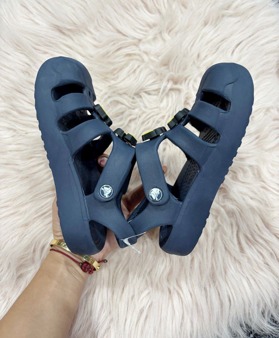 Navy Blue Crocs Sandals with Excavator Jibbitz (Category: Babies & Kids Fashion) located in Digos. Submitted by kathydiane76376 (Listing ID 1463695438, Image 2). Description: - Navy blue Crocs sandals for kids - Features fun yellow excavator Jibbitz on front straps - Easy velcro closure for a secure fit - Comfortable and durable material - Ideal for summer adventures and playtime - Perfect for little construction vehicle fans.