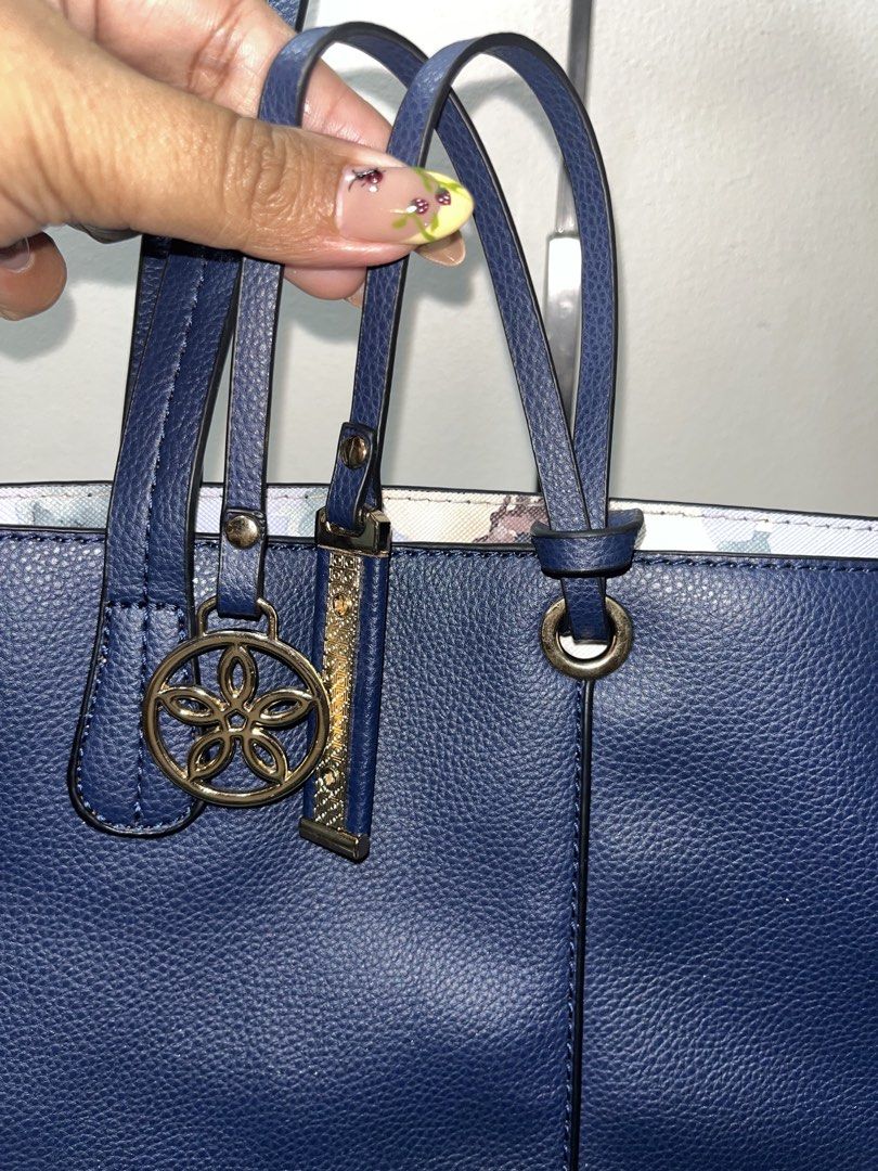 Navy Blue Reversible Tote Bag with Floral Interior (Category: Tote Bags) located in Liloan. Submitted by sakurumifinds2809 (Listing ID 1463721321, Image 3). Description: - Navy blue tote bag - Reversible with a pretty floral print lining - Open tote - Includes a decorative charm - Spacious interior for essentials - Comfortable shoulder straps - Perfect for everyday use or travel.