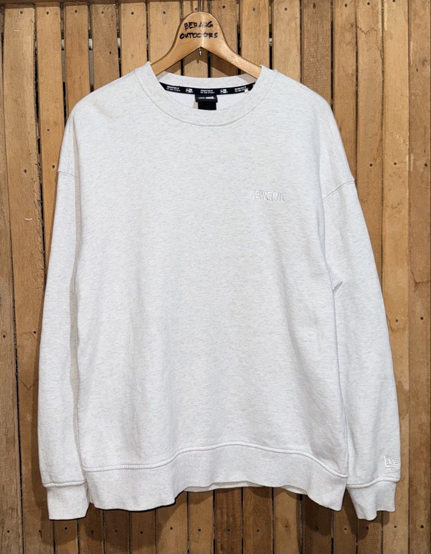 New Era Grey Crewneck Sweatshirt (Category: Coats, Jackets and Outerwear) located in Maramag. Submitted by ghab82885 (Listing ID 1463590207, Image 1). Description: New Era Crewneck Sweatshirt Excellent condition Embroidered logo Size Medium on tag W23” x L27” 380 Only.