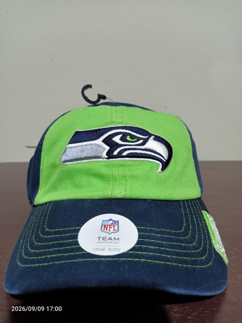 NFL Seattle Seahawks Team Apparel Cap (Category: Caps & Hats) located in Las Pinas. Submitted by OmengSoyT (Listing ID 1463703813, Image 2). Description: - Authentic Seattle Seahawks NFL cap - Embroidered team logo on front - Navy blue and lime green colorway - NFL Team Apparel tag attached -Brandnew - One size fits most.Adjustable - Perfect for Seahawks fans.