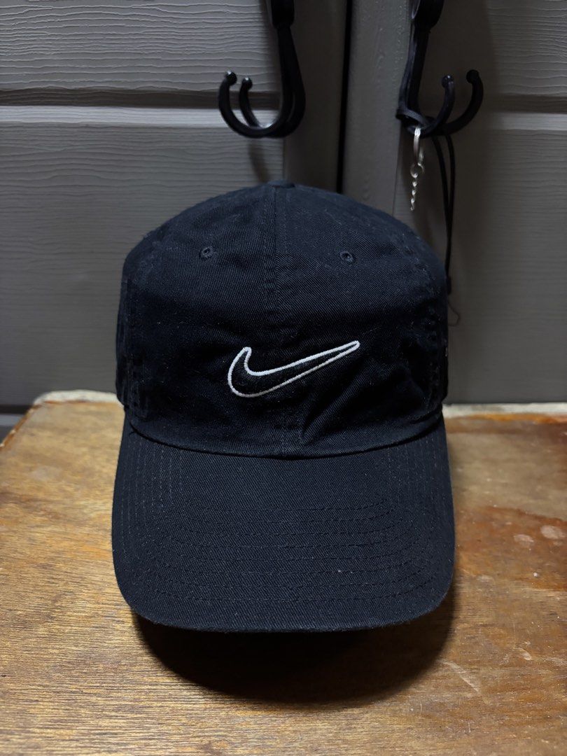 Nike Black Baseball Cap with White Swoosh Logo (Category: Caps & Hats) located in Pasig City. Submitted by abogadosupremo (Listing ID 1463626638, Image 1). Description: - Classic black Nike cap - Iconic white embroidered swoosh logo - Adjustable strap for a comfortable fit - Ideal for everyday wear or sports - Simple and stylish design - 100% Legit and Authentic - Very Good Condition - Color may vary due to lighting - No issue at all - Size : One