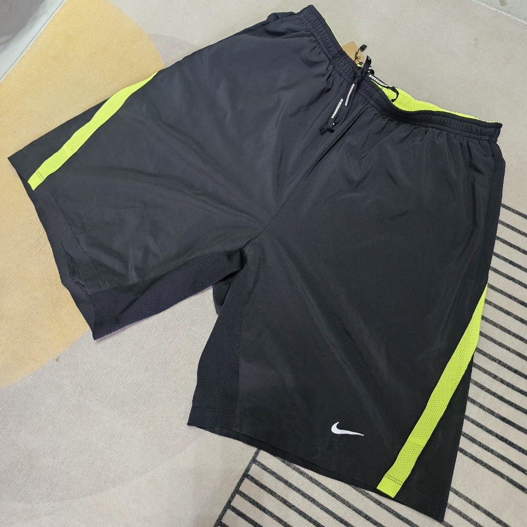 Nike Drifir Neon blacK Shorts (Category: Shorts) located in Baguio. Submitted by kayeonlineshop (Listing ID 1463619309, Image 1). Description: black Nike Dri-FIT athletic shorts featuring neon green side panels and a white Swoosh logo on the leg W28-36 L 19 h26.