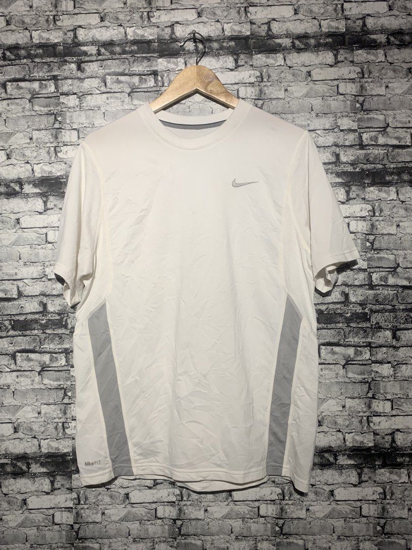 Nike Dri-FIT White Running T-Shirt (Category: Activewear) located in Manila. Submitted by marksaban81396 (Listing ID 1463673612, Image 2). Description: NIKE DRIFIT FOR RUNNING SIZE MEDUIM WIDTH 20 LENGHT 27 Color rate 9.5/10 No issue Excellent condition - White Nike Dri-FIT T-Shirt - Ideal for running and workouts - Breathable fabric for comfort - Stylish grey paneling on the sides - Classic Nike logo on the chest - Versatile for everyday active 