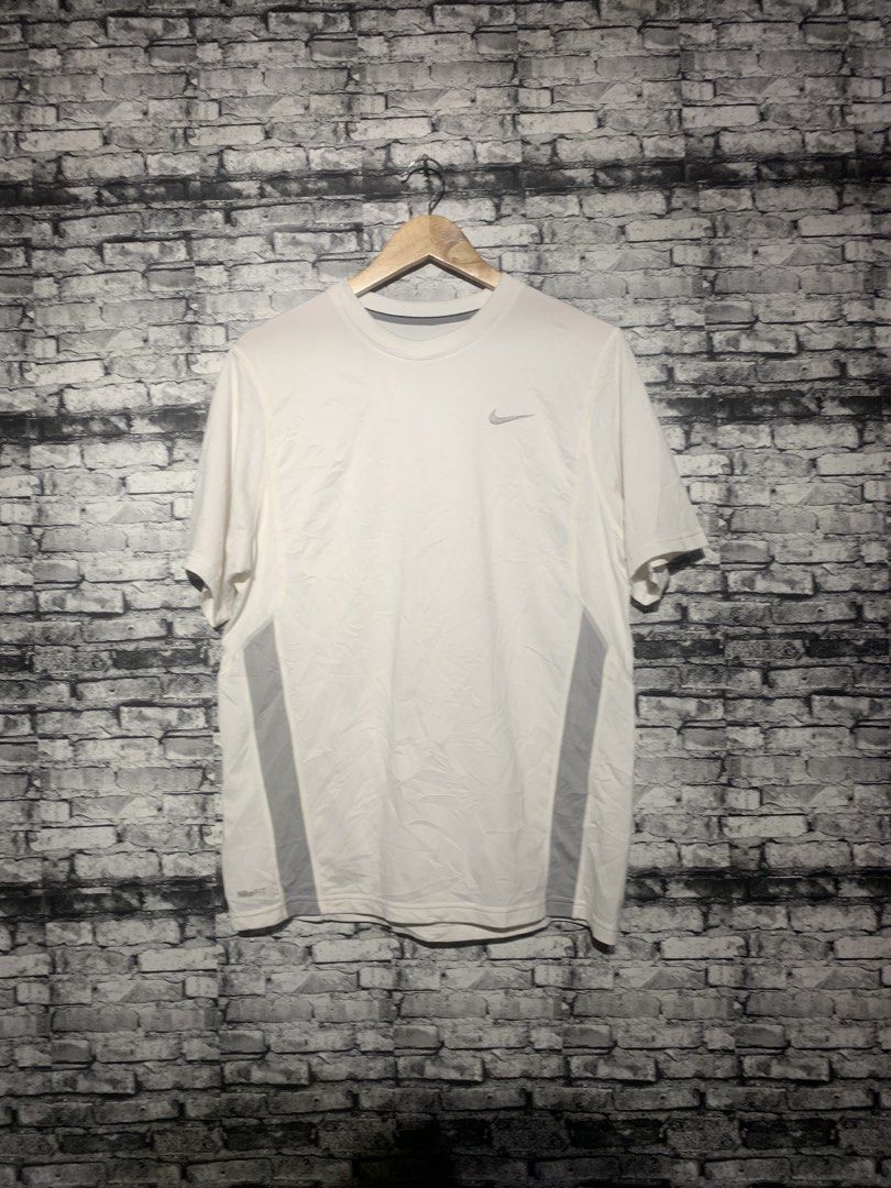 Nike Dri-FIT White Running T-Shirt (Category: Activewear) located in Manila. Submitted by marksaban81396 (Listing ID 1463673612, Image 3). Description: NIKE DRIFIT FOR RUNNING SIZE MEDUIM WIDTH 20 LENGHT 27 Color rate 9.5/10 No issue Excellent condition - White Nike Dri-FIT T-Shirt - Ideal for running and workouts - Breathable fabric for comfort - Stylish grey paneling on the sides - Classic Nike logo on the chest - Versatile for everyday active 
