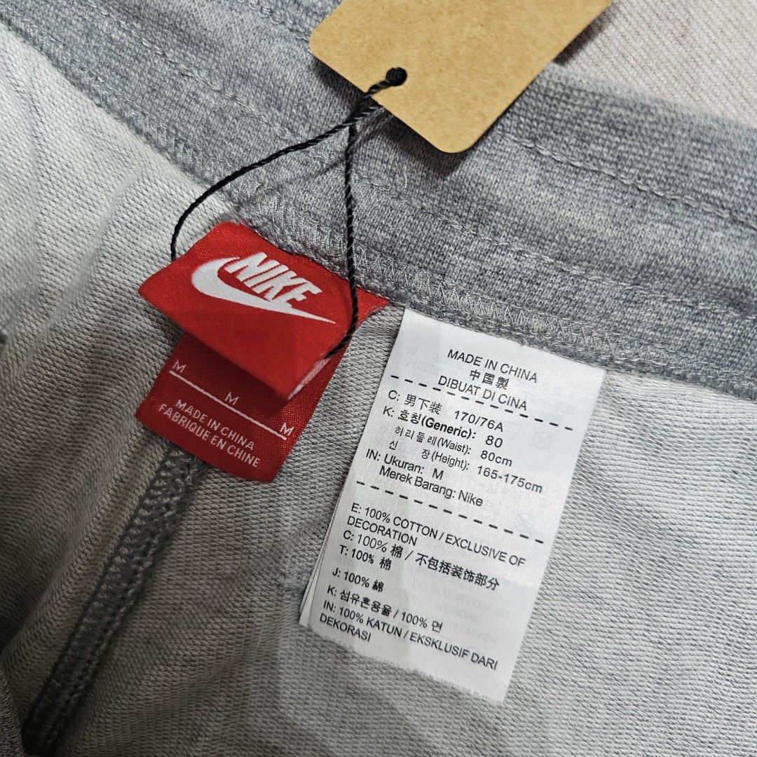 Nike Gray Shorts (Category: Shorts) located in Baguio. Submitted by kayeonlineshop (Listing ID 1463618193, Image 2). Description: grey Nike Club Alumni French Terry shorts featuring a prominent white logo on the left leg and an adjustable drawstring waistband w30-36 L19 h23.