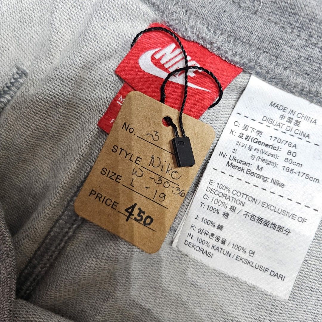 Nike Gray Shorts (Category: Shorts) located in Baguio. Submitted by kayeonlineshop (Listing ID 1463618193, Image 3). Description: grey Nike Club Alumni French Terry shorts featuring a prominent white logo on the left leg and an adjustable drawstring waistband w30-36 L19 h23.