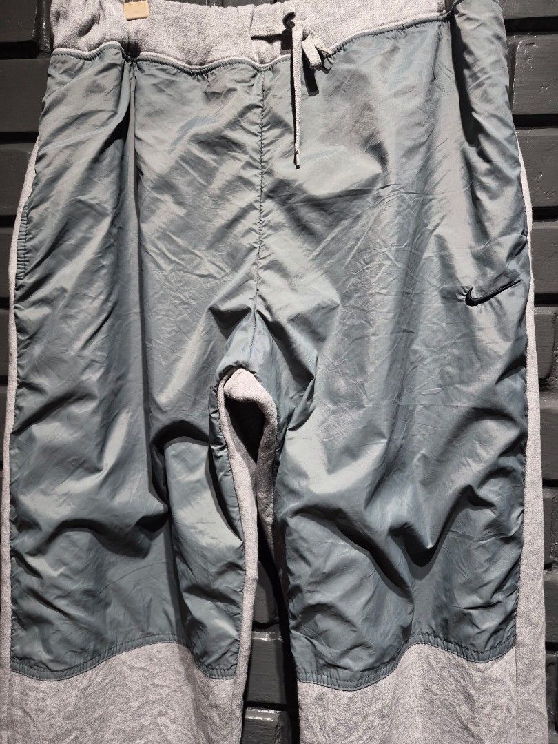 Nike Grey Sweatpants with Nylon Panels (Category: Joggers) located in Davao. Submitted by rodrigoani57168 (Listing ID 1463603184, Image 1). Description: - Baggy Y2K Fleece - Grey Nike track pants - Mix of fleece and nylon panels - Adjustable drawstring waist - Elasticated cuffs with toggles - Small Nike swoosh logos on front and leg - Ideal for casual wear or workouts - Color Rate: 9.5/10 - No issue -Excellent Condition - Dimes: WaistLine: 32 inc