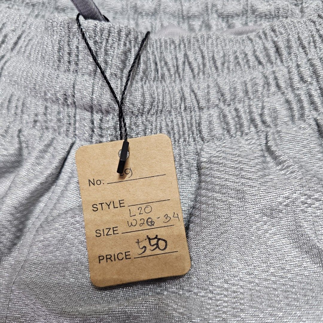 Nike Sport Shorts (Category: Shorts) located in Baguio. Submitted by kayeonlineshop (Listing ID 1463621150, Image 3). Description: silver-gray Nike shiny dazzle basketball shorts featuring a white Swoosh logo near the lower left hem. w26-34 L20 h24.