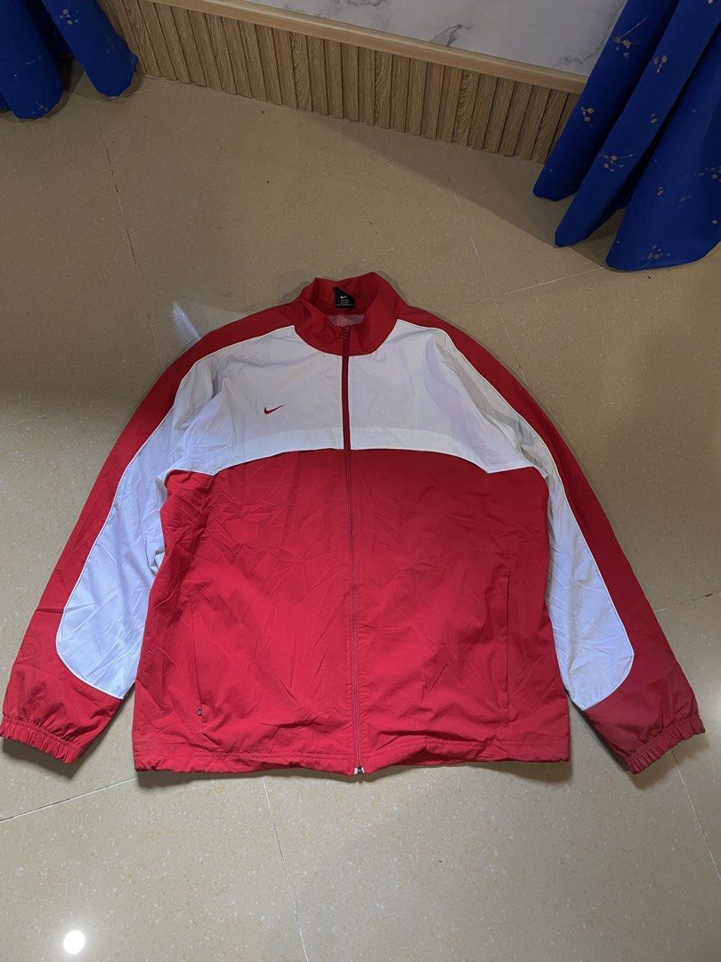 Nike VNTG White Track Jacket (Category: Coats, Jackets and Outerwear) located in Davao. Submitted by loythrift30 (Listing ID 1463628199, Image 1). Description: - Classic Nike track jacket - Red and white colorway - Features iconic Nike swoosh logo - Zipper closure - Mesh lining inside - Size: XL - Ideal for sports or casual wear.