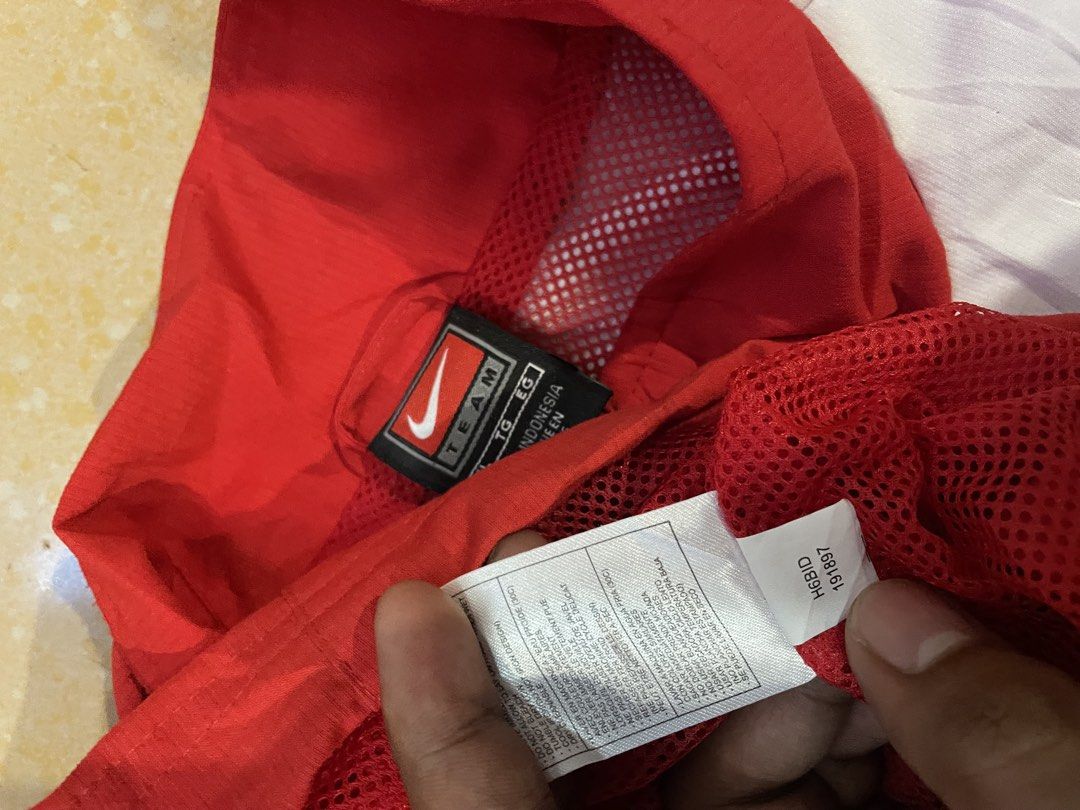 Nike VNTG White Track Jacket (Category: Coats, Jackets and Outerwear) located in Davao. Submitted by loythrift30 (Listing ID 1463628199, Image 3). Description: - Classic Nike track jacket - Red and white colorway - Features iconic Nike swoosh logo - Zipper closure - Mesh lining inside - Size: XL - Ideal for sports or casual wear.