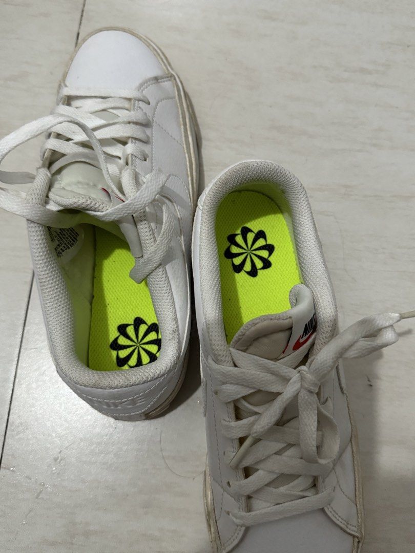 Nike White Sneakers (Category: Sneakers) located in Pasig City. Submitted by jigzzzzz (Listing ID 1463556301, Image 3). Description: -Original Nike - Classic white Nike low-top sneakers - Iconic Nike swoosh detail on the side - Soles show minor wear, still offer great grip - Bright green insoles with black Nike logo - Ideal for casual and everyday wear -Rarely use siguro mga 5x lang nagamit.
