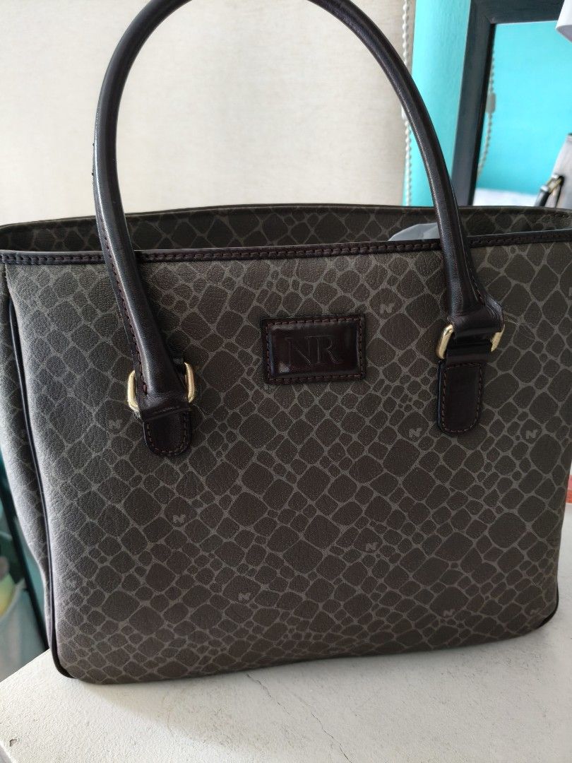 Nina Ricci Tote Bag (Category: Luxury Bags & Wallets) located in Paranaque City. Submitted by onlineshopwithsec (Listing ID 1463569570, Image 1). Description: - Classic Nina Ricci tote bag - All-over monogram pattern - Dark brown leather trim and handles - Zipper closure at the top - Interior zippered compartment - Great for everyday use lenght 8" width 9".