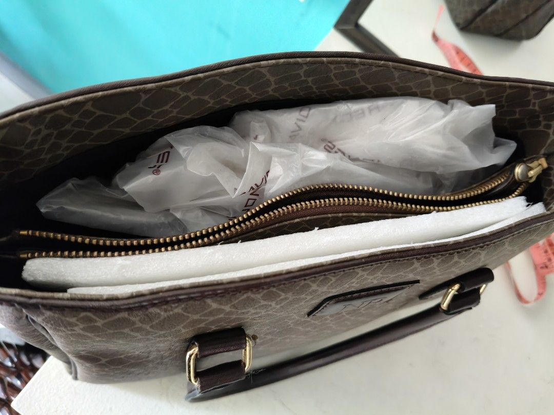 Nina Ricci Tote Bag (Category: Luxury Bags & Wallets) located in Paranaque City. Submitted by onlineshopwithsec (Listing ID 1463569570, Image 2). Description: - Classic Nina Ricci tote bag - All-over monogram pattern - Dark brown leather trim and handles - Zipper closure at the top - Interior zippered compartment - Great for everyday use lenght 8" width 9".