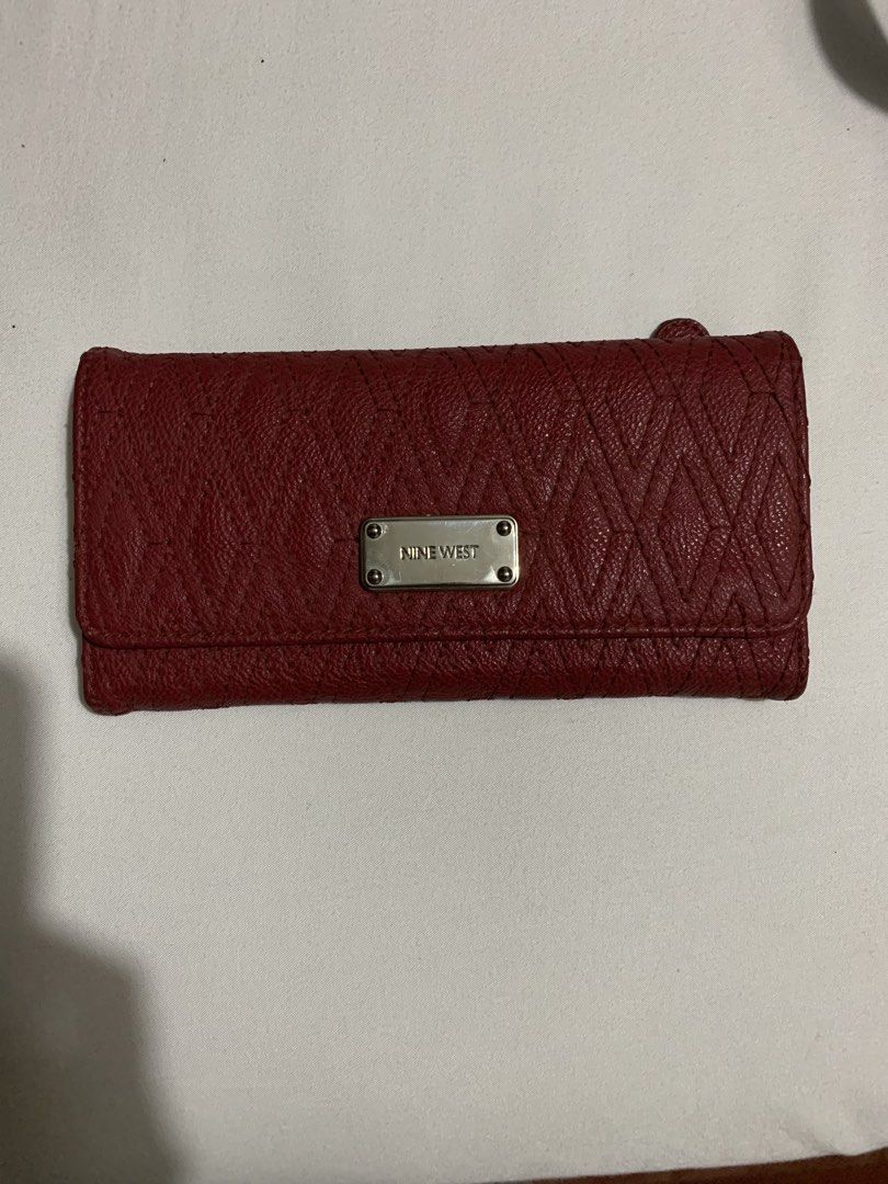Nine West Red Textured Long Wallet (Category: Wallets & Card holders) located in Cavite. Submitted by honeyjmo (Listing ID 1463589218, Image 1). Description: - Chic red Nine West wallet - Textured exterior with a stylish diamond pattern - Convenient zip pocket on the back - Interior boasts multiple card slots for organization - Includes a clear ID window for easy access - Ample space for all your daily necessities - Ideal for everyday use -Authen