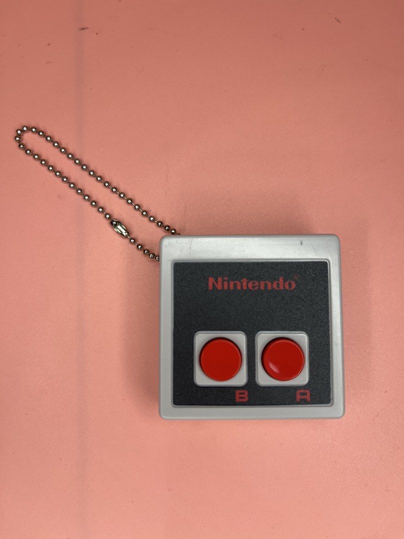 Nintendo Store Gashapon Controller (Category: Interactive Toys) located in Caloocan City. Submitted by snapshop_ph (Listing ID 1463620523, Image 1). Description: - Authentic Nintendo Store Gashapon collectible - Mini replica of the classic NES controller - Features iconic red A and B buttons - Durable keychain attachment - Perfect for fans of retro gaming.