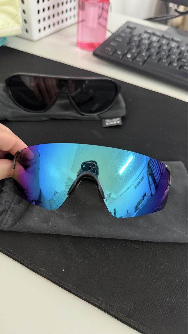 Oakley Sunglasses (Category: Sunglasses & Eyewear) located in Naic. Submitted by joancust (Listing ID 1463577986, Image 1). Description: - Authentic Oakley sunglasses - Sleek black frames - Blue-purple tinted lenses - Includes soft pouches.