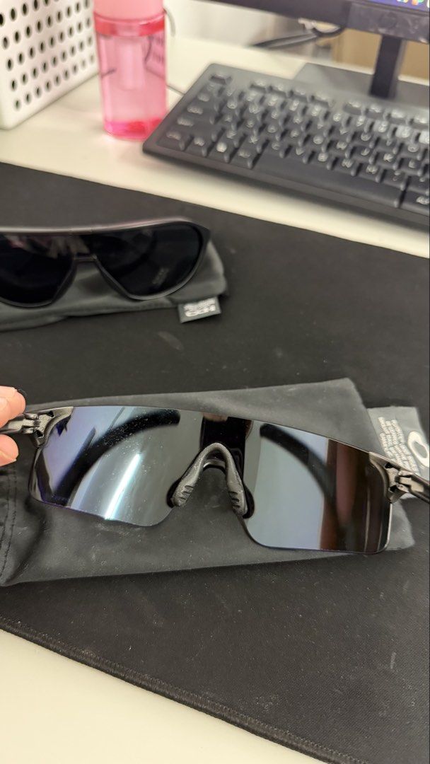 Oakley Sunglasses (Category: Sunglasses & Eyewear) located in Naic. Submitted by joancust (Listing ID 1463577986, Image 2). Description: - Authentic Oakley sunglasses - Sleek black frames - Blue-purple tinted lenses - Includes soft pouches.