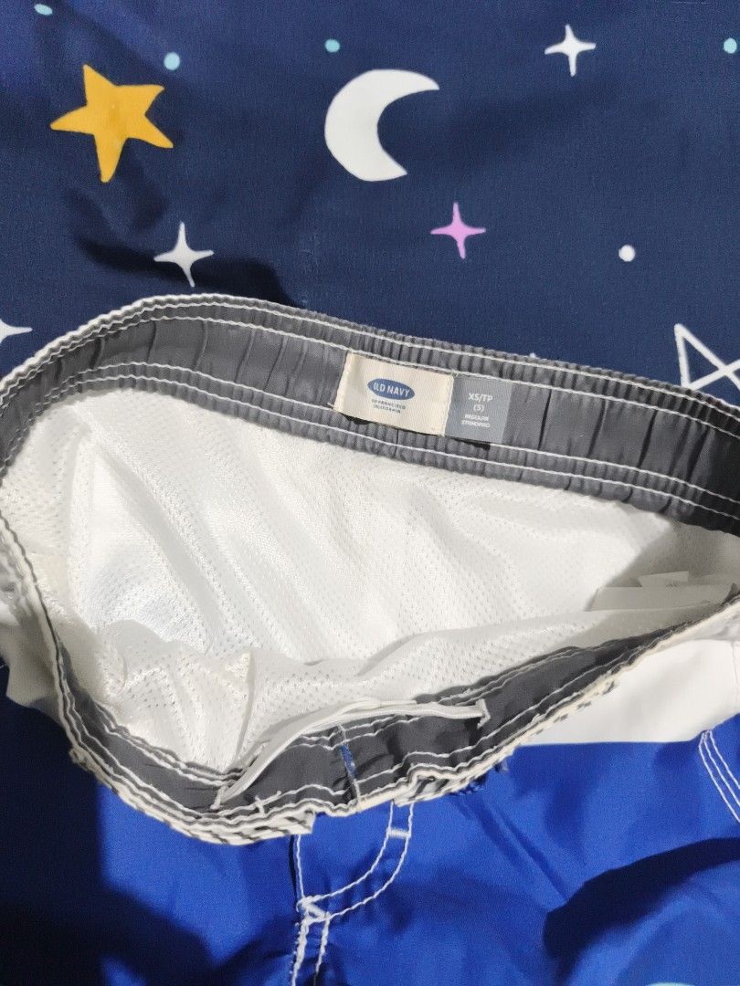 Old Navy Boys Swim Trunks Size XS/TP (Category: Swim Trunks & Board Shorts) located in Manila. Submitted by goeunlee (Listing ID 1463699501, Image 3). Description: - Brand: Old Navy - Size: XS / TP (Toddler/Preschool) - Design: Colorful stripes in blue, mint green, and grey - Features: Elastic waistband with adjustable drawstring, built-in mesh lining - Ideal for: Beach days, pool parties, and summer adventures.