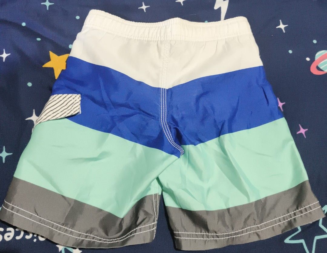 Old Navy Boys Swim Trunks Size XS/TP (Category: Swim Trunks & Board Shorts) located in Manila. Submitted by goeunlee (Listing ID 1463699501, Image 2). Description: - Brand: Old Navy - Size: XS / TP (Toddler/Preschool) - Design: Colorful stripes in blue, mint green, and grey - Features: Elastic waistband with adjustable drawstring, built-in mesh lining - Ideal for: Beach days, pool parties, and summer adventures.