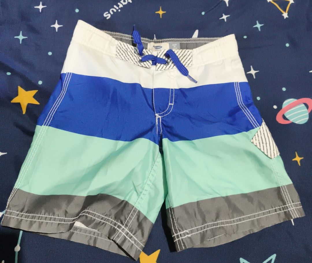 Old Navy Boys Swim Trunks Size XS/TP (Category: Swim Trunks & Board Shorts) located in Manila. Submitted by goeunlee (Listing ID 1463699501, Image 1). Description: - Brand: Old Navy - Size: XS / TP (Toddler/Preschool) - Design: Colorful stripes in blue, mint green, and grey - Features: Elastic waistband with adjustable drawstring, built-in mesh lining - Ideal for: Beach days, pool parties, and summer adventures.